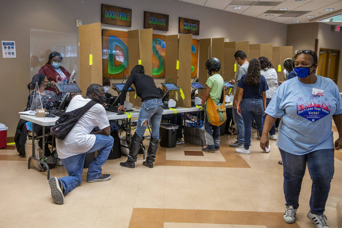 Voters begin the check-in process at the Doolittle Community Center voter center during Electio ...