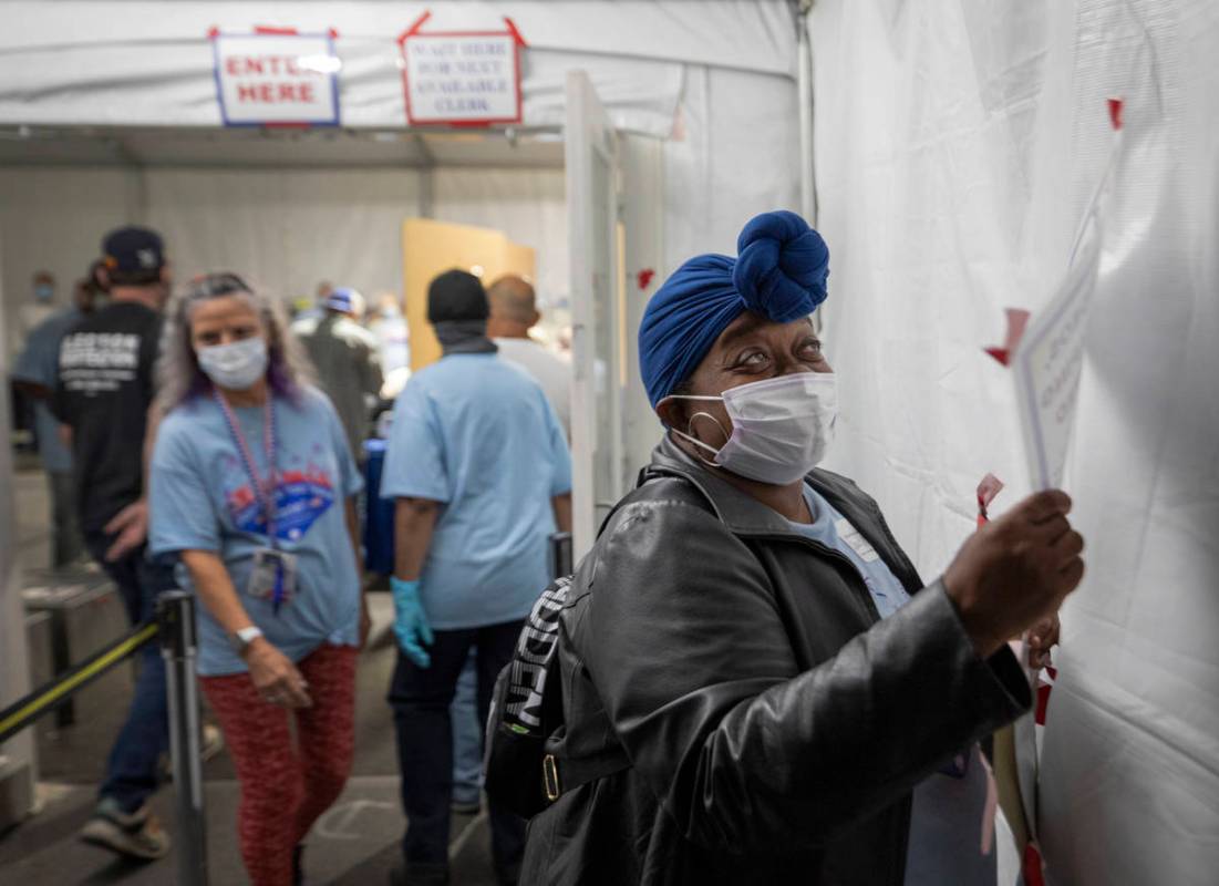 Volunteer monitor Dawnye Moore, 52, of Las Vegas, takes down the Vote signs after the polling s ...