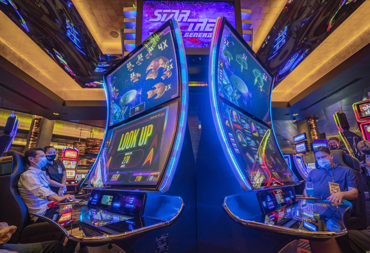 Individuals play Aristocrat Technologies' new Star Trek: The Next Generation Slot Game during t ...