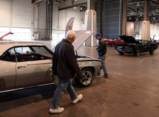 Guests, who declined to give their names, check out a 1969 Chevy Camaro at the Las Vegas Conven ...