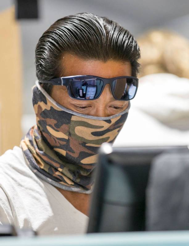 Voter Justin Nguyen casts his votes at the Meadows Mall vote center location during Election Da ...