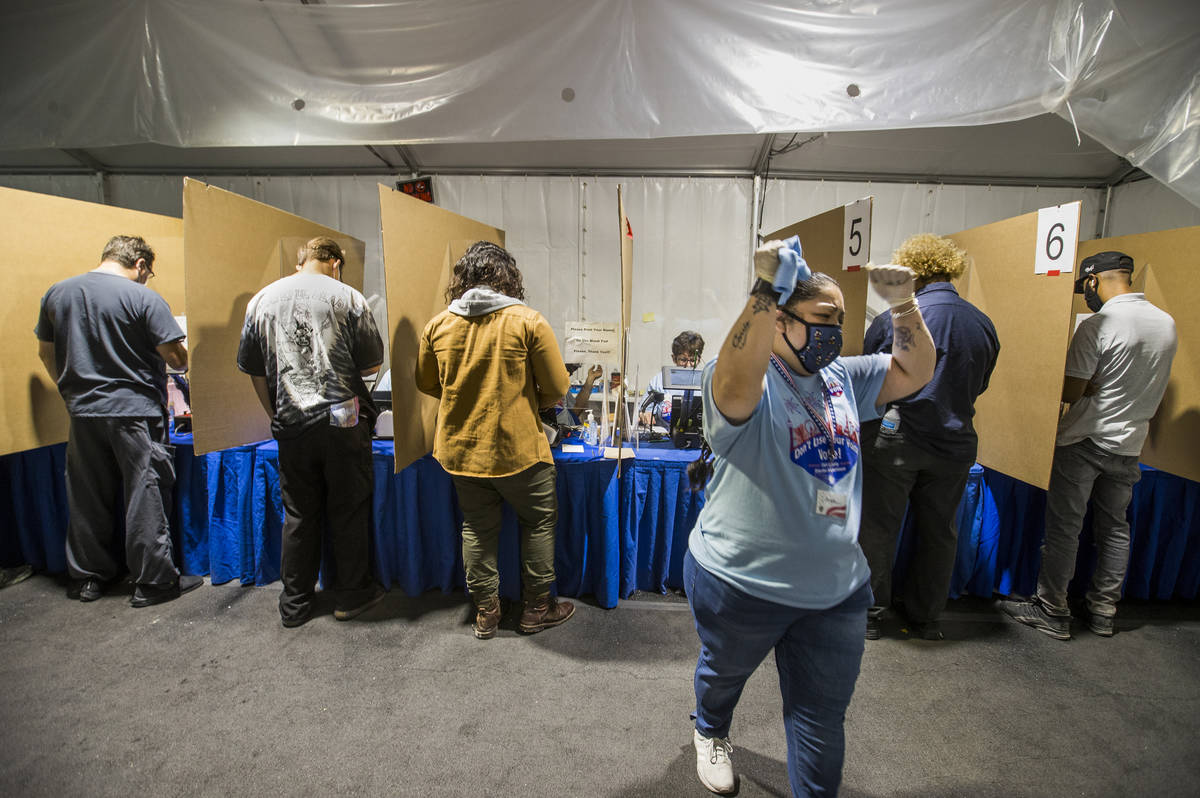 Worker Angie Hernandez celebrates another first-time voter at the LVAC Rainbow voter center dur ...