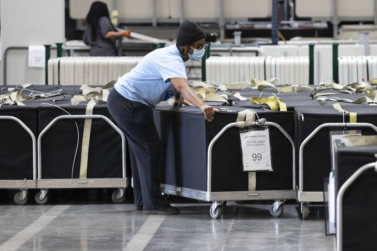 A Clark County election worker arranges voting machines at the Election Center on Wednesday, No ...