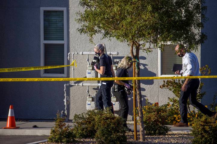 Crime scene investigators document the scene outside after four were killed and one injured in ...