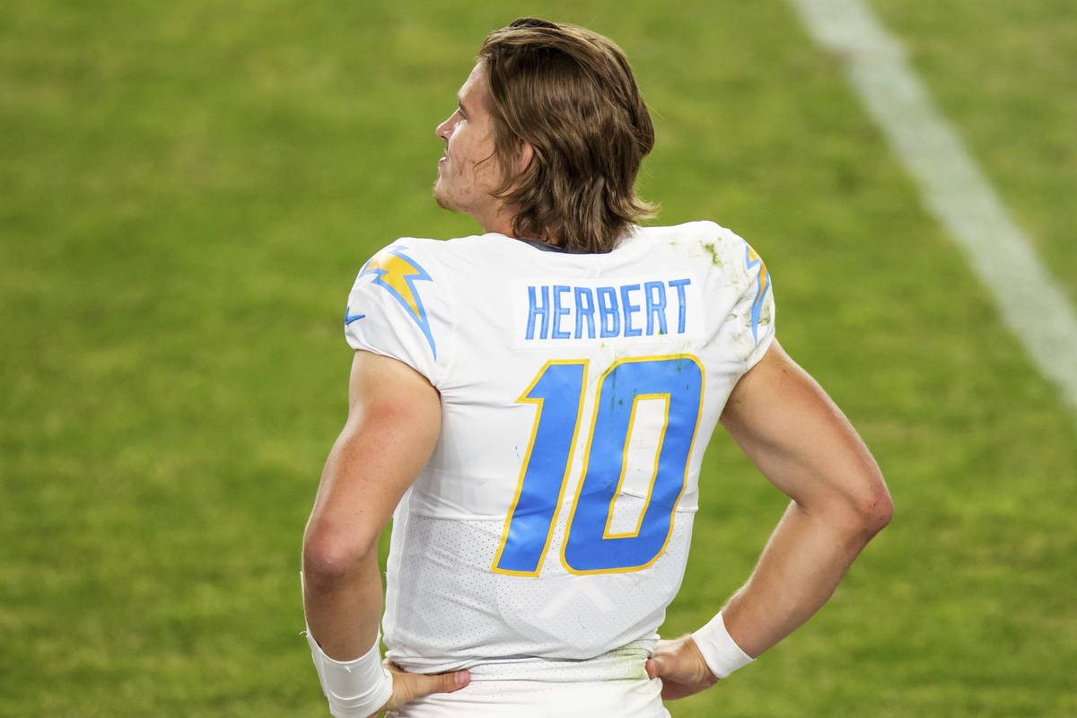 Los Angeles Chargers quarterback Justin Herbert (10) stands on the sidelines against the Denver ...