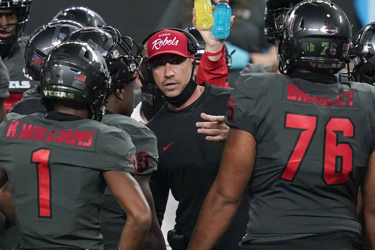 UNLV head coach Marcus Arroyo speaks with his players during the second half of an NCAA college ...