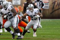 Las Vegas Raiders running back Devontae Booker (23) runs with the football against the Clevelan ...