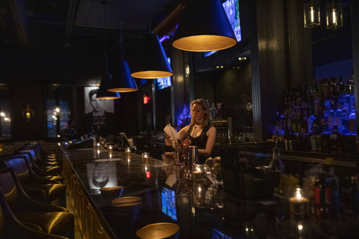 Bar tender Sarah Alexander makes a cocktail at the newly renovated concept bar The Bank, at Gam ...