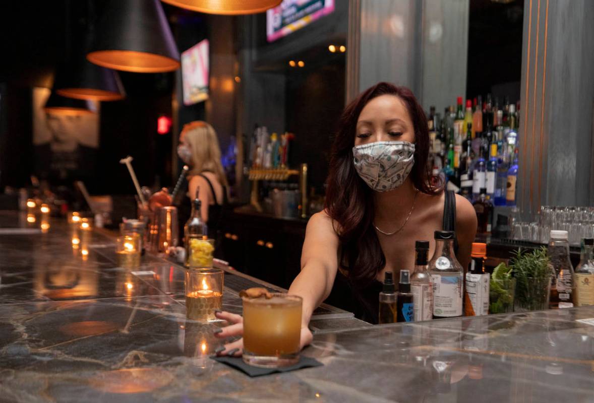 Bar tender Kendall Hauer serves a signature fall cocktail in the newly renovated The Bank, at ...