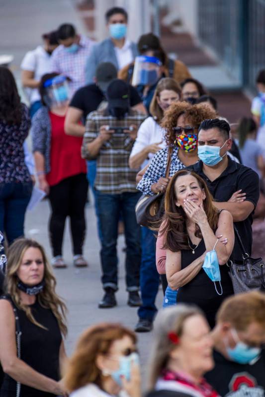 Voter Deborah Dunn of Las Vegas, right, awaits in line with others to cure their votes due to v ...