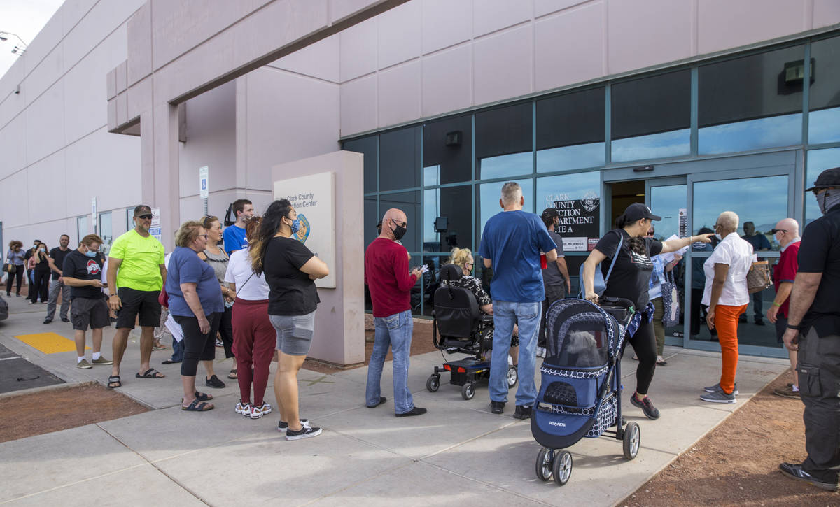 Voters gather in line to cure their votes due to various issues outside the Clark County Electi ...