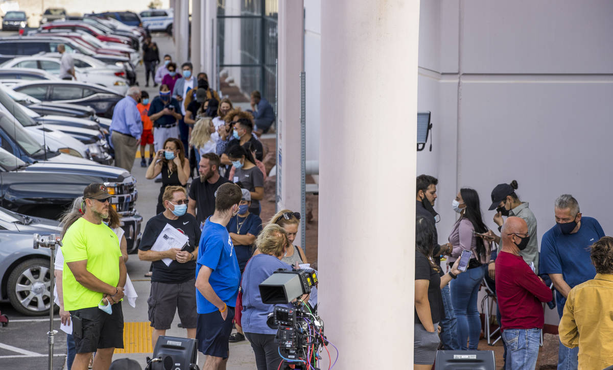 Voters gather in line to cure their votes due to various issues outside the Clark County Electi ...