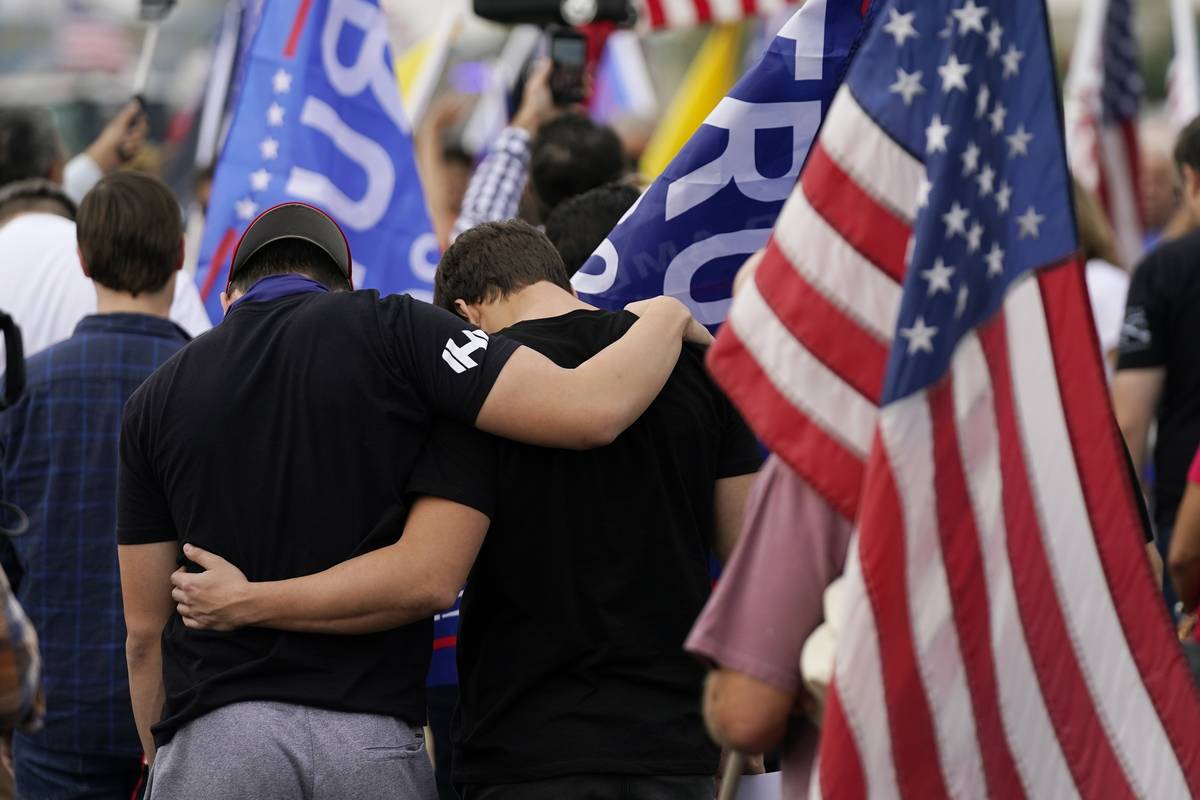 Supporters of President Donald Trump pause in prayer at a rally outside the Maricopa County Rec ...