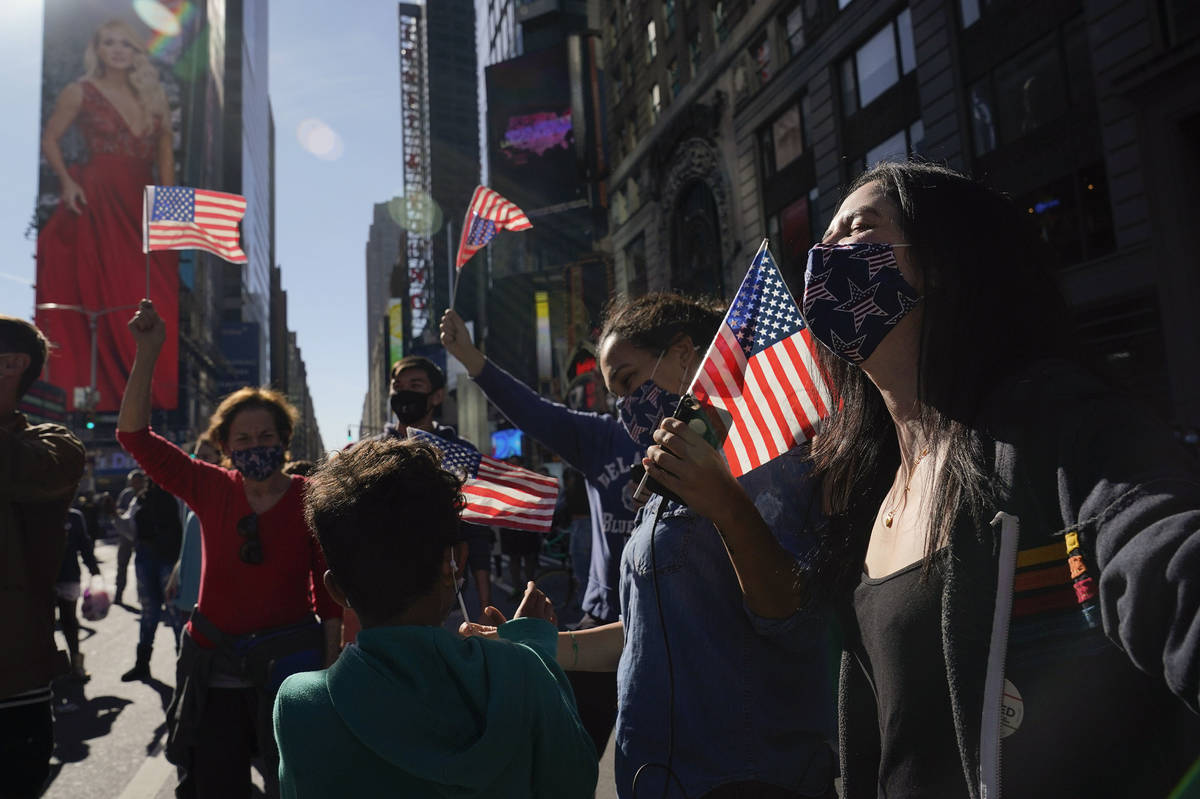 People celebrate in Times Square after former vice president and Democratic presidential candid ...