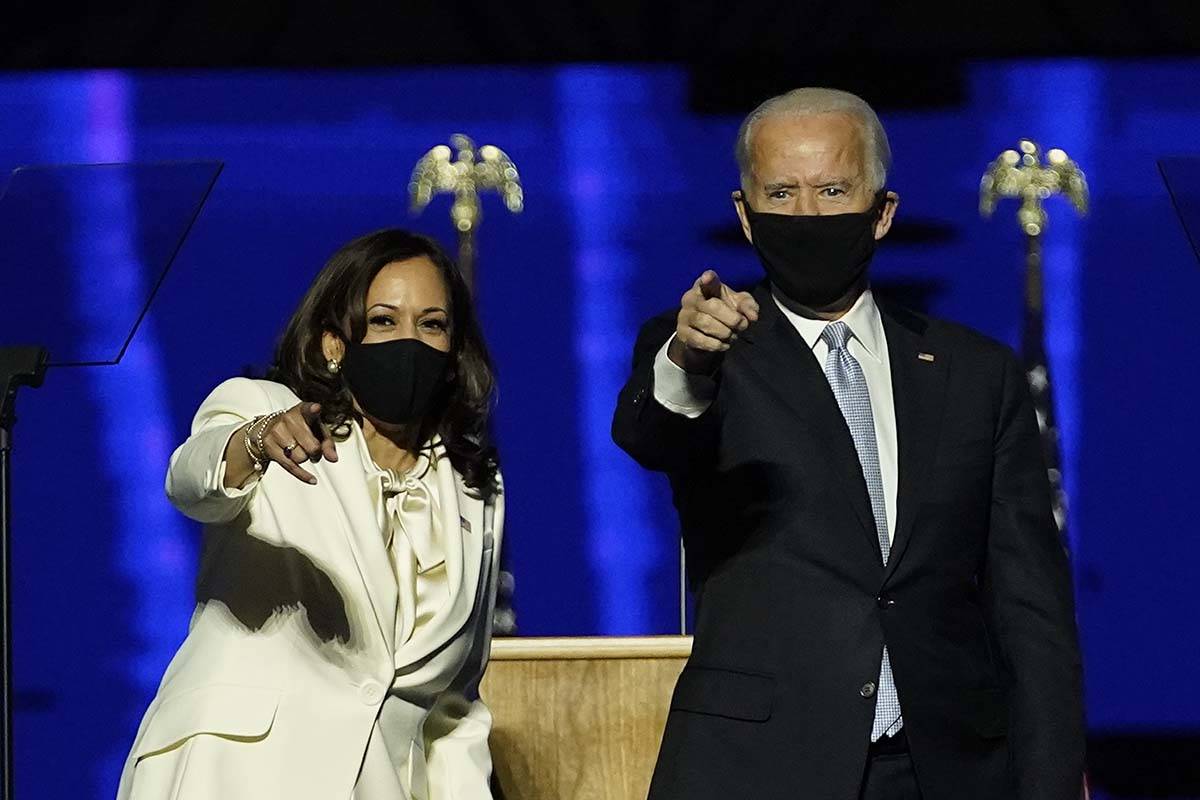 Vice President-elect Kamala Harris and President-elect Joe Biden stand on stage together, Satur ...