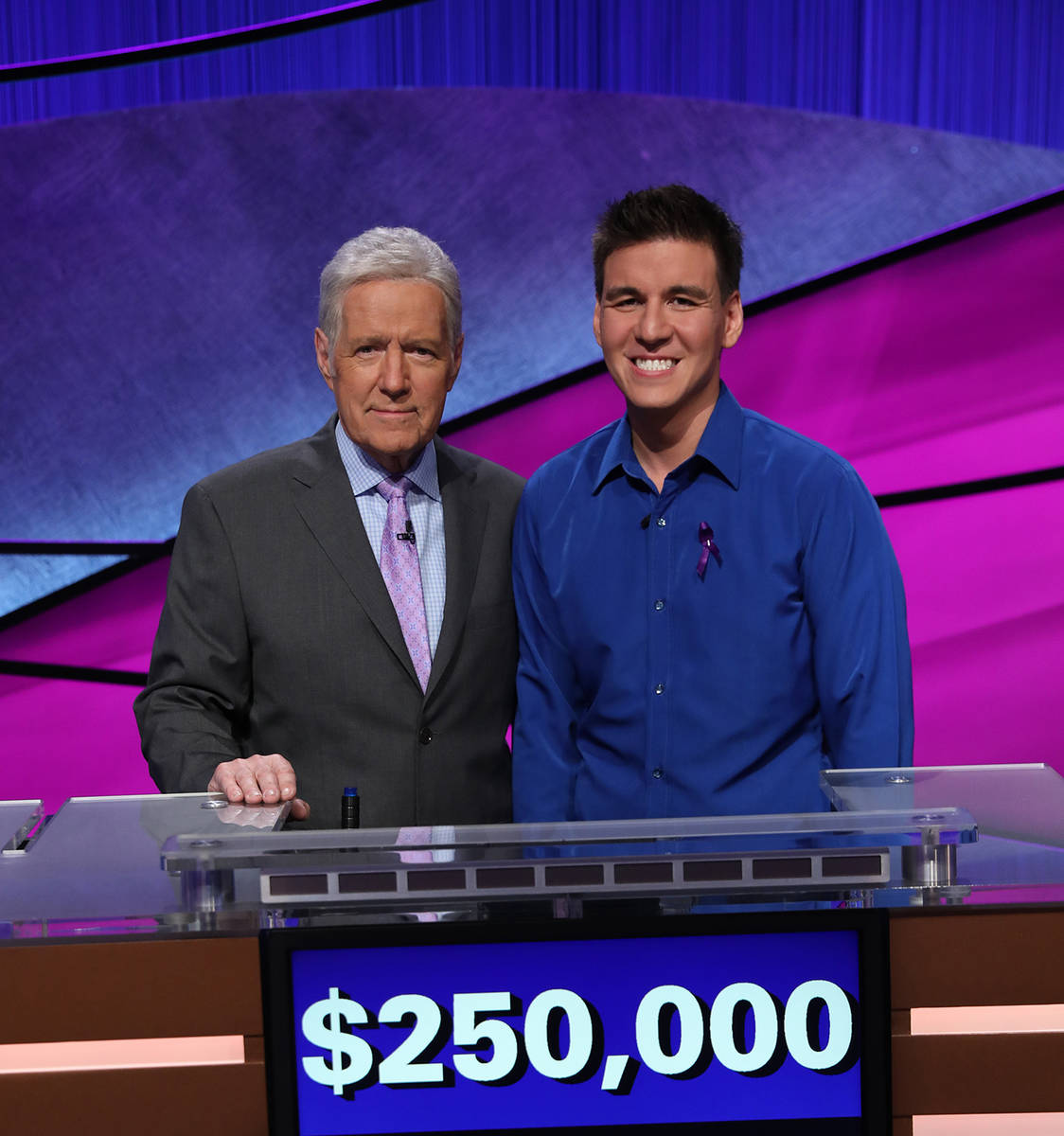 “Jeopardy!” host Alex Trebek, left, and Las Vegan James Holzhauer are shown after the Tourn ...