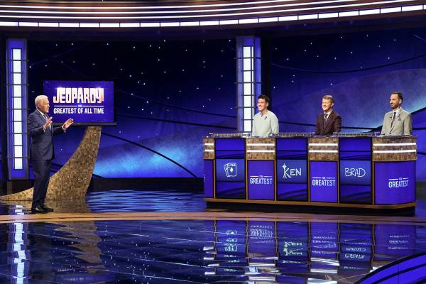 In this image released by ABC, host Alex Trebec, left, appear with contestants, James Holzhauer ...
