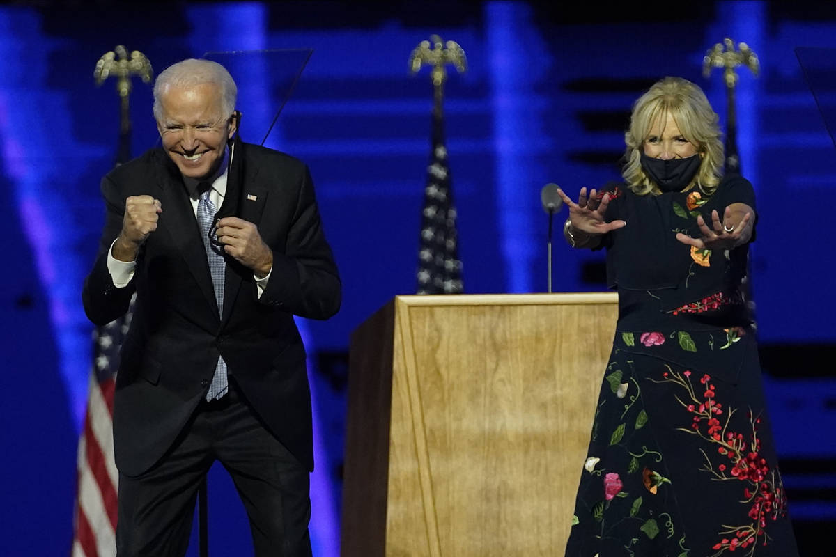 President-elect Joe Biden and wife Jill Biden gesture to supporters Saturday, Nov. 7, 2020, in ...