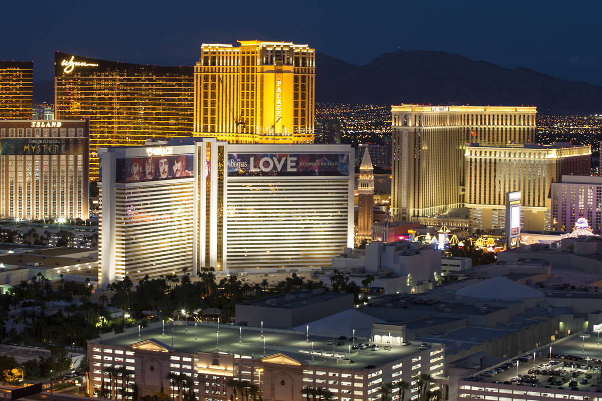 The Strip skyline lights up at dusk as seen from the VooDoo Lounge atop the Rio hotel-casino in ...