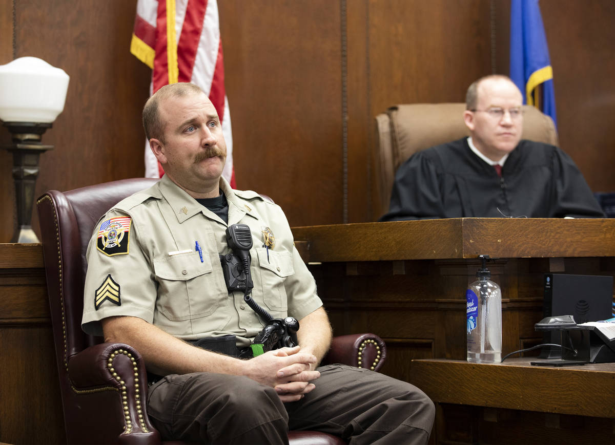 White Pine County Sheriff's Office Sgt. Nathan Mingo, left, testifies about his jail interactio ...