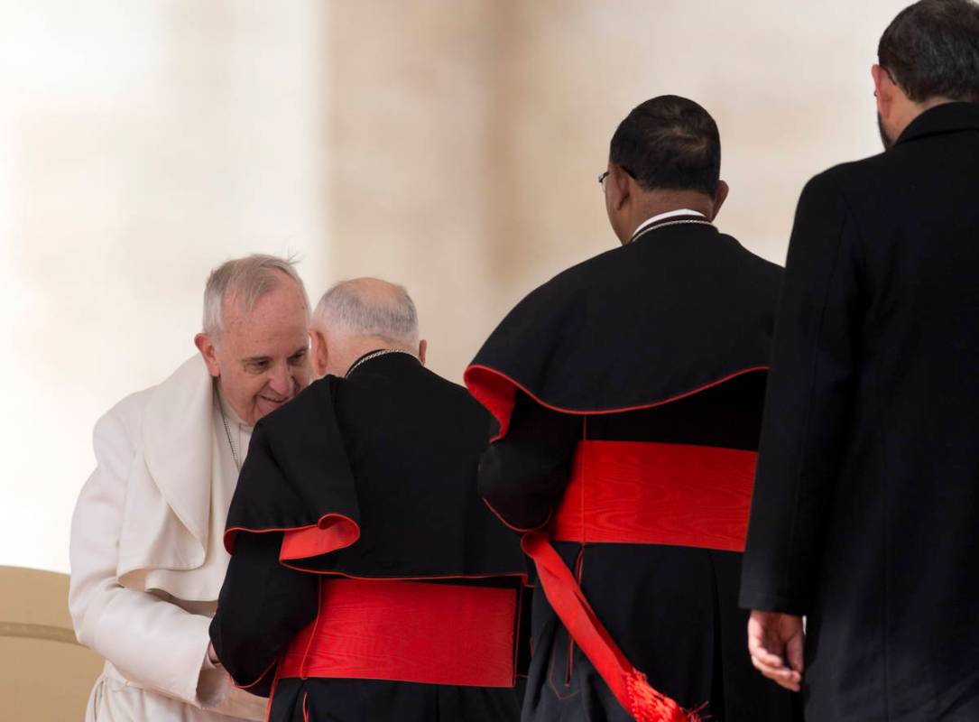 FILE - In this Feb. 19, 2014 file photo, Pope Francis greets U.S. Cardinal Theodore Edgar McCar ...