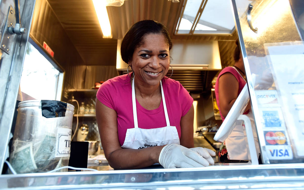 Denette Braud peers out one of the windows of her Funnel Cake Cafe food trailer in 2015 in Las ...