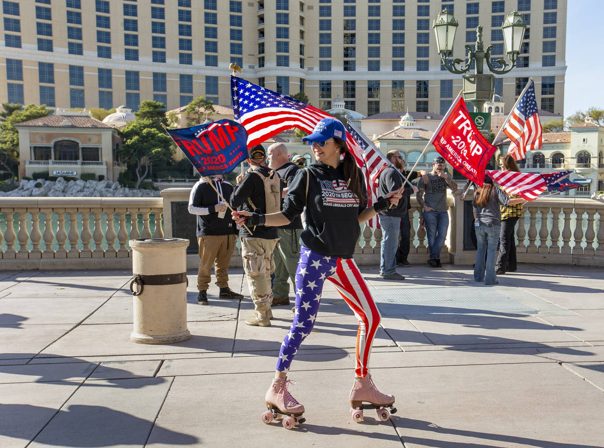 Christy Kettler skates about the Bellagio during a Veterans Day march to peacefully protest Gov ...