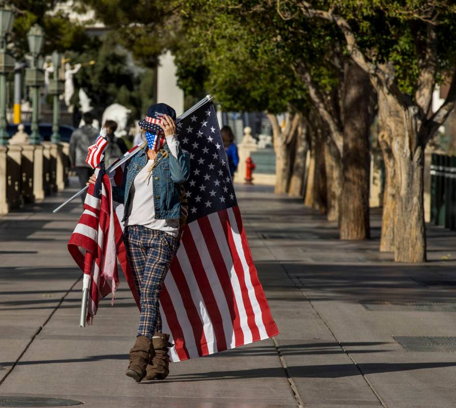 Wetoniah Houlihan walks with others near the Bellagio during a Veterans Day march to peacefully ...