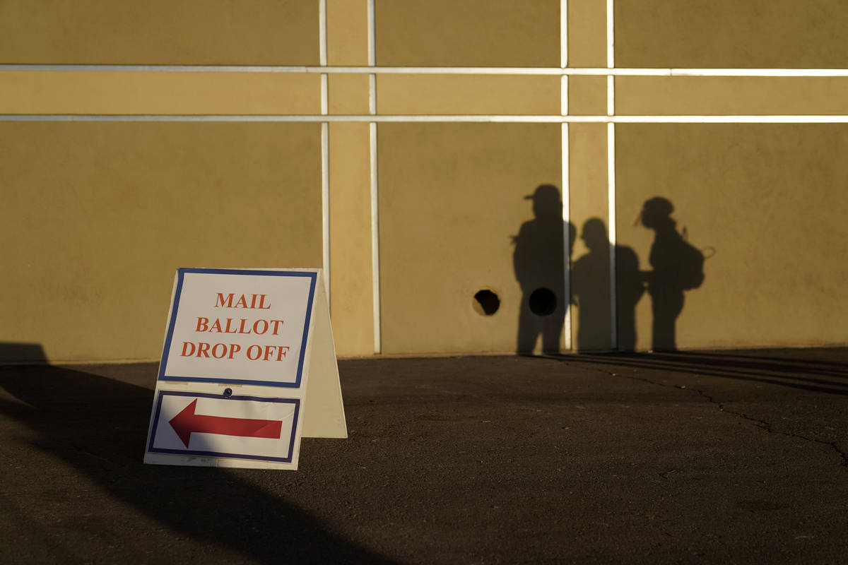 FILE - In this Nov. 3, 2020, file photo people wait outside of a polling place on Election Day ...