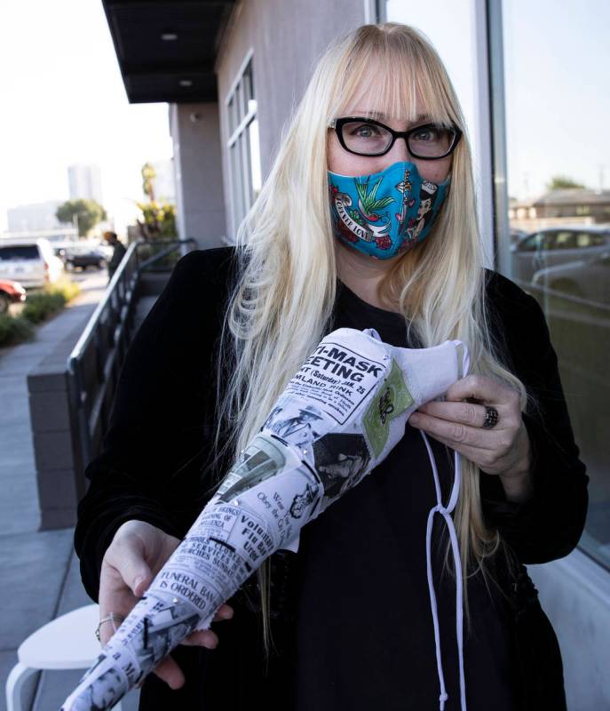 A local fashion designer, Anna Bartoletti, shows off her "Full Circle" mask as she ...
