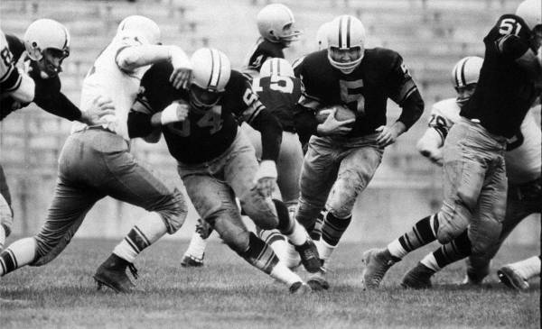 FILE - In this Aug. 10, 1959 file photo, Paul Hornung (5) of the Green Bay Packers goes through ...