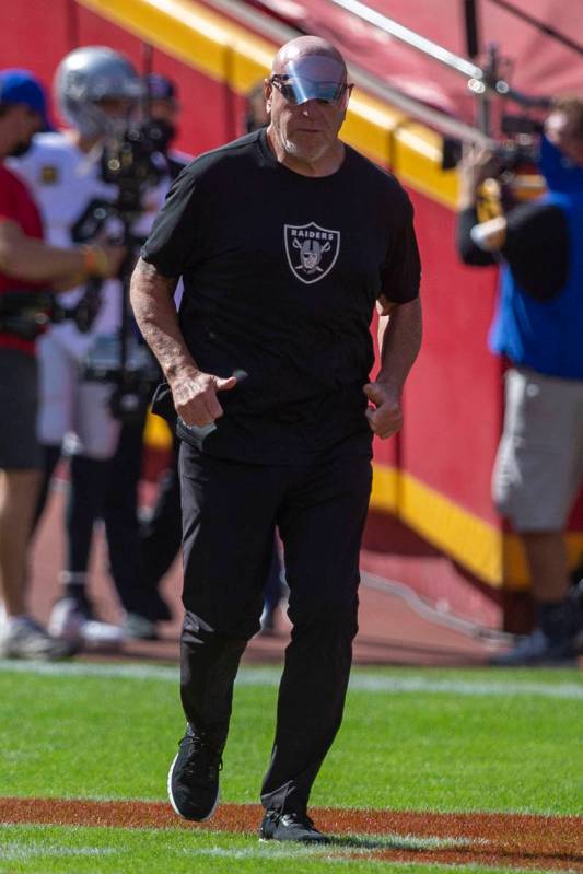 Las Vegas Raiders offensive line coach Tom Cable runs on the field before an NFL football game ...