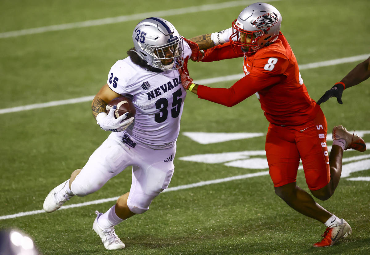 UNR Wolf Pack running back Toa Taua (35) runs the ball against New Mexico Lobos cornerback Dont ...