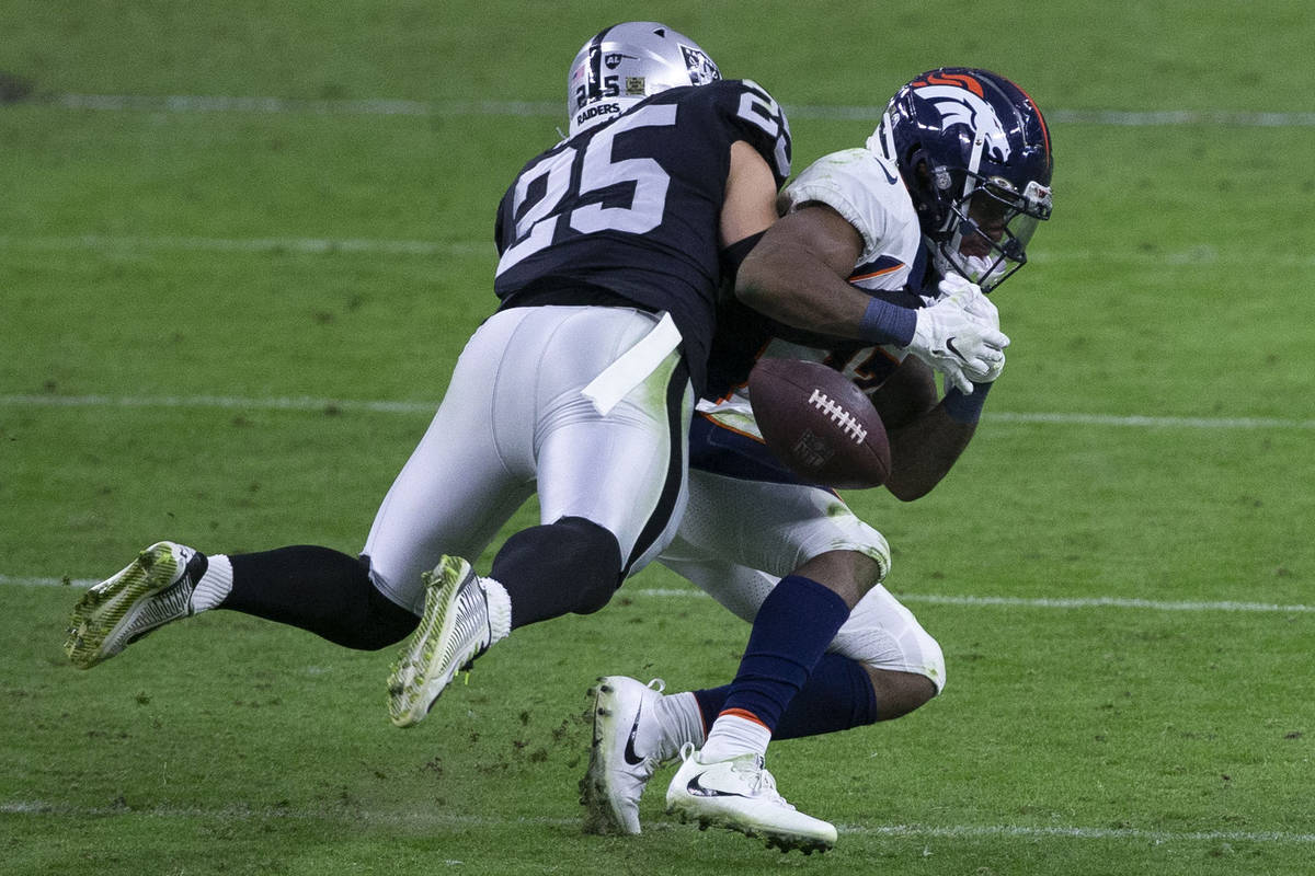 Las Vegas Raiders free safety Erik Harris (25) forces the football out of the hands of Denver B ...