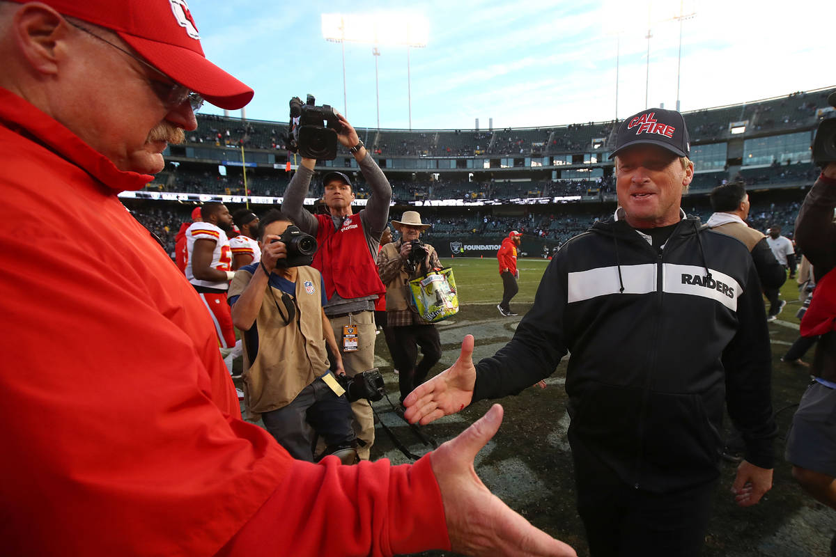 Kansas City Chiefs head coach Andy Reid, left, shakes hands with Oakland Raiders head coach Jon ...