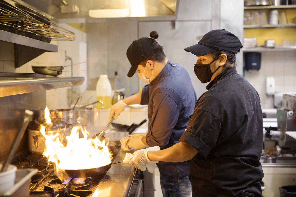 Chef Omar Velazquez, left, and Chef Denise Ortiz, right, cook in the kitchen at Pasta Shop Rist ...