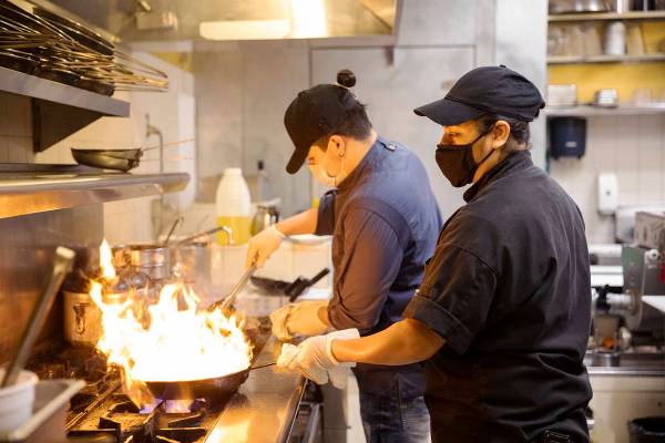 Chef Omar Velazquez, left, and Chef Denise Ortiz, right, cook in the kitchen at Pasta Shop Rist ...