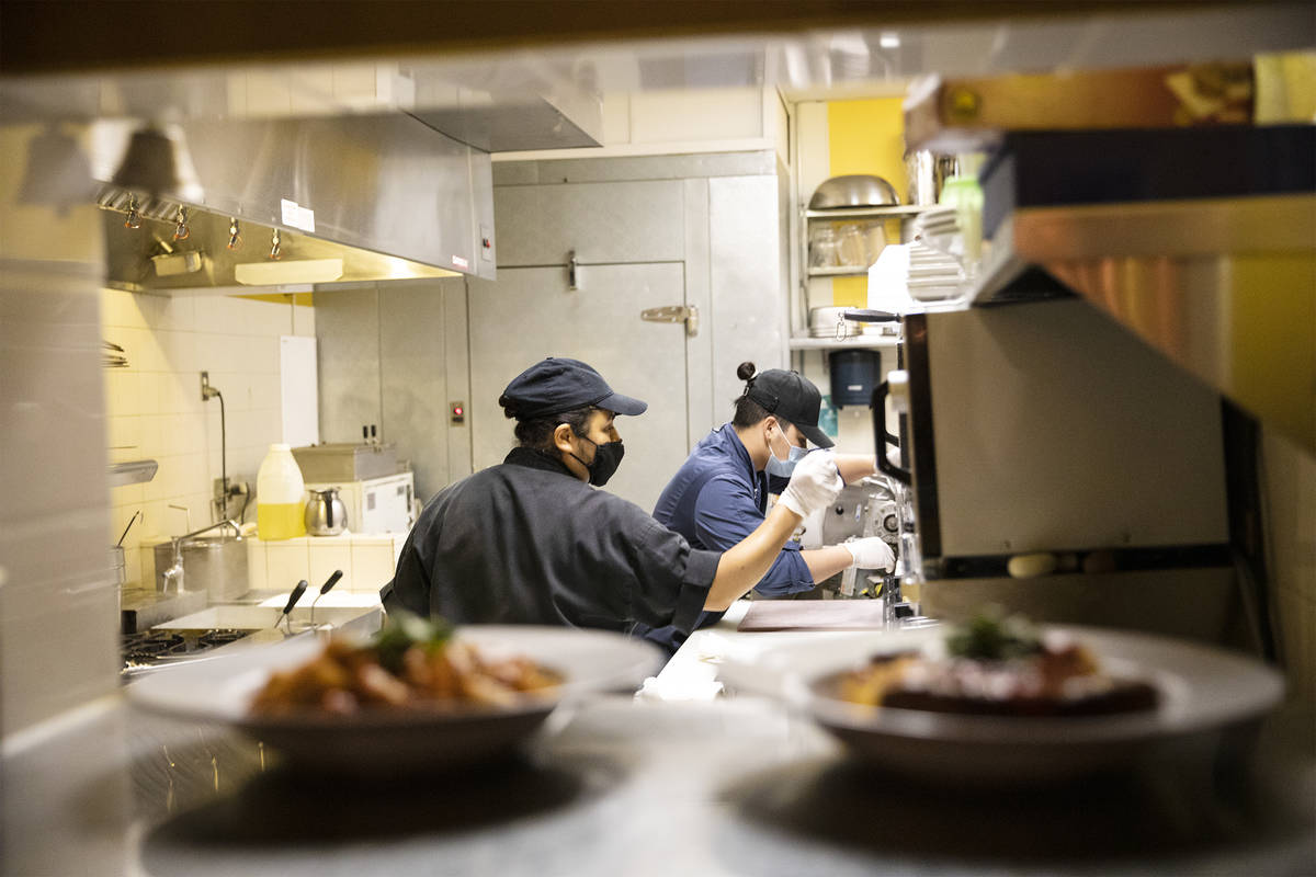 Chef Denise Ortiz, left, and Chef Omar Velazquez, right, cook for the dinner rush at Pasta Shop ...