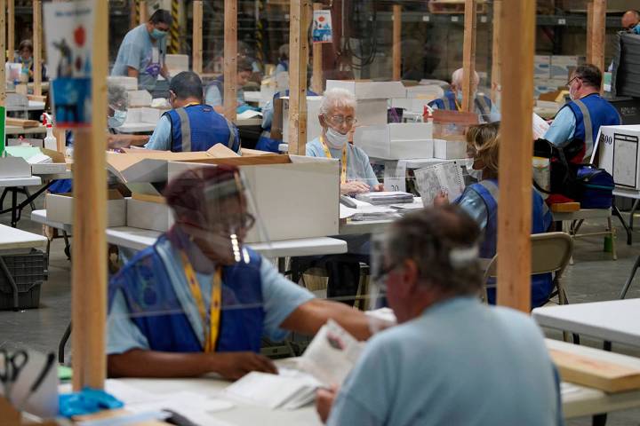 Election workers process mail-in ballots during a nearly all-mail primary election in Las Vegas ...