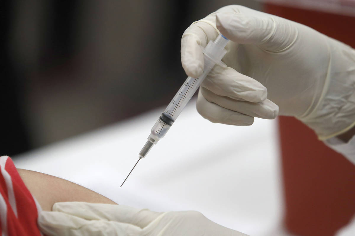 In this Thursday, Jan. 23, 2020 file photo, a patient receives an influenza vaccine in Mesquite ...