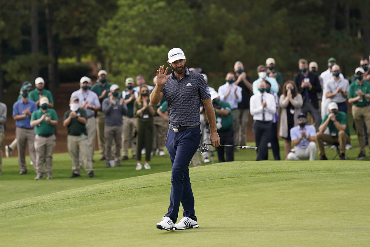 Dustin Johnson waves after winning the Masters golf tournament Sunday, Nov. 15, 2020, in August ...
