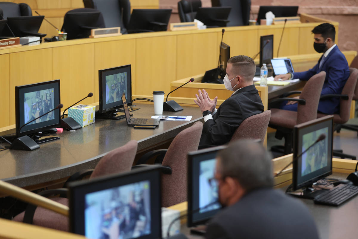 Chief Deputy District Attorney Michael Dickerson, center, watches police body camera footage sh ...