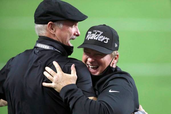 Las Vegas Raiders GM Mike Mayock, left, embraces head coach Jon Gruden after defeating the New ...