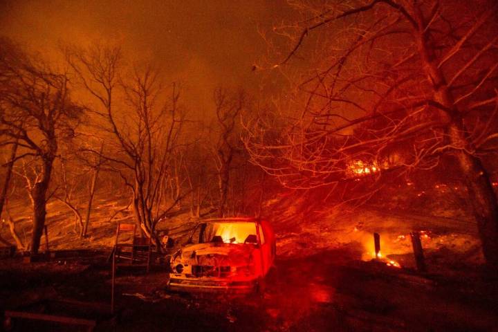 A burned vehicle is seen in the Lake Hughes Fire in Angeles National Forest on Thursday, Aug. 1 ...