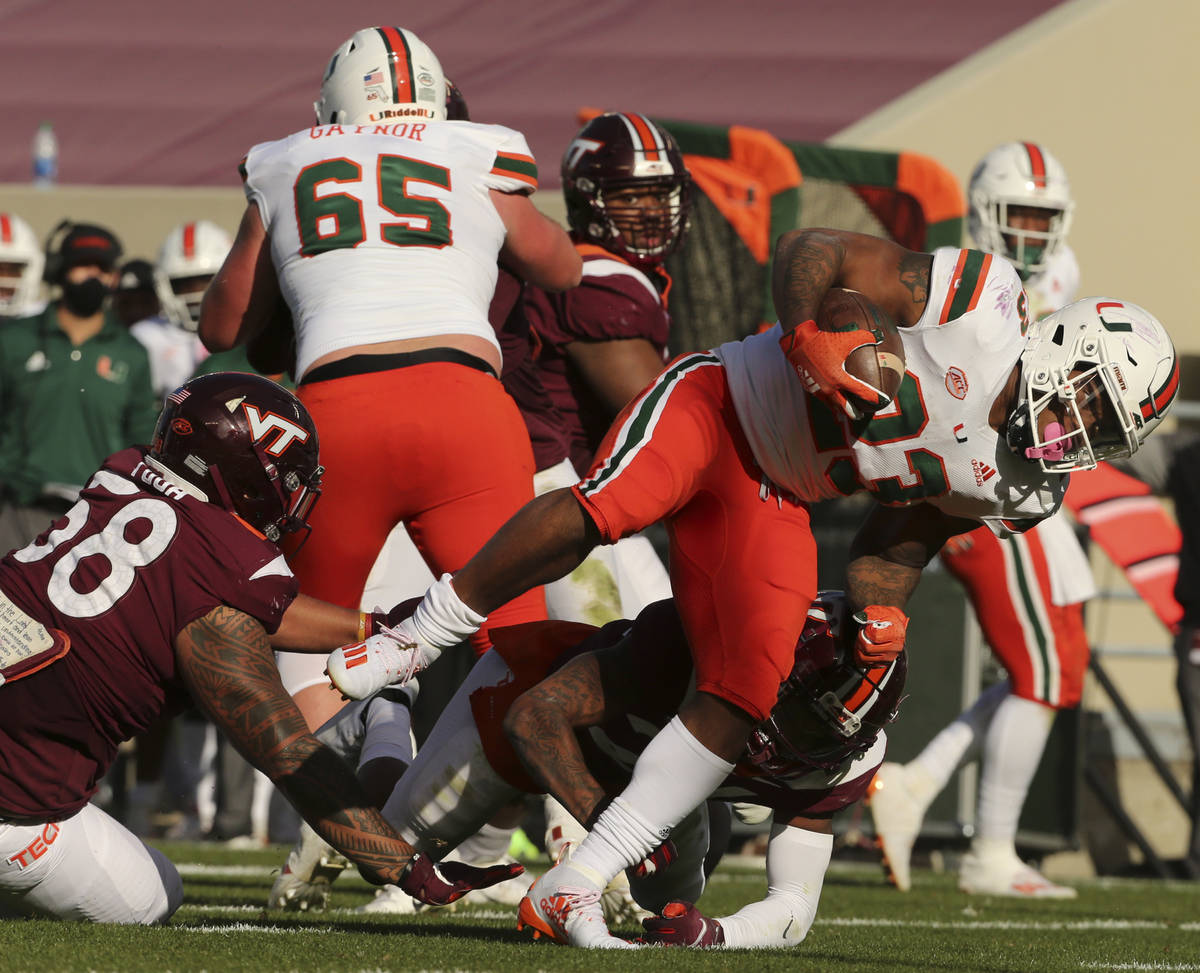 Miami's Cam'Ron Harris scores a touchdown past the Virginia Tech defense during the second half ...