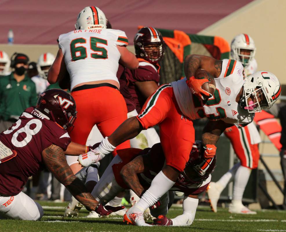 Miami's Cam'Ron Harris scores a touchdown past the Virginia Tech defense during the second half ...