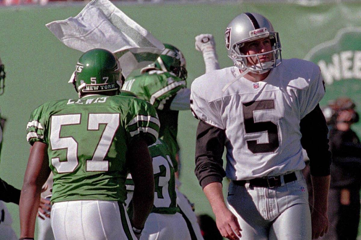 Oakland Raiders kicker Cole Ford (5) turns away as New York Jets' Mo Lewis (57) and other teamm ...