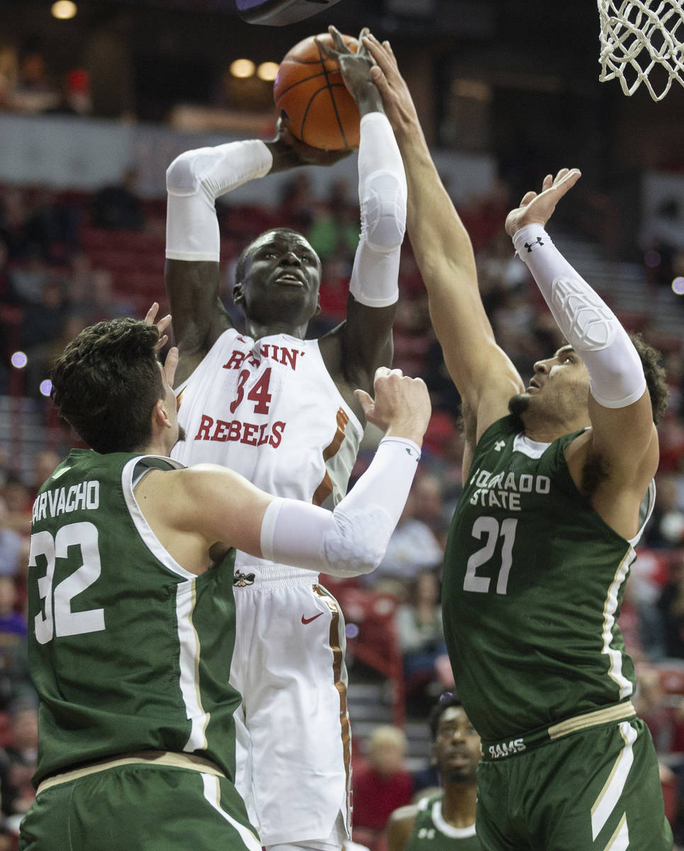 UNLV Rebels forward Cheikh Mbacke Diong (34) shoots over Colorado State Rams center Nico Carvac ...