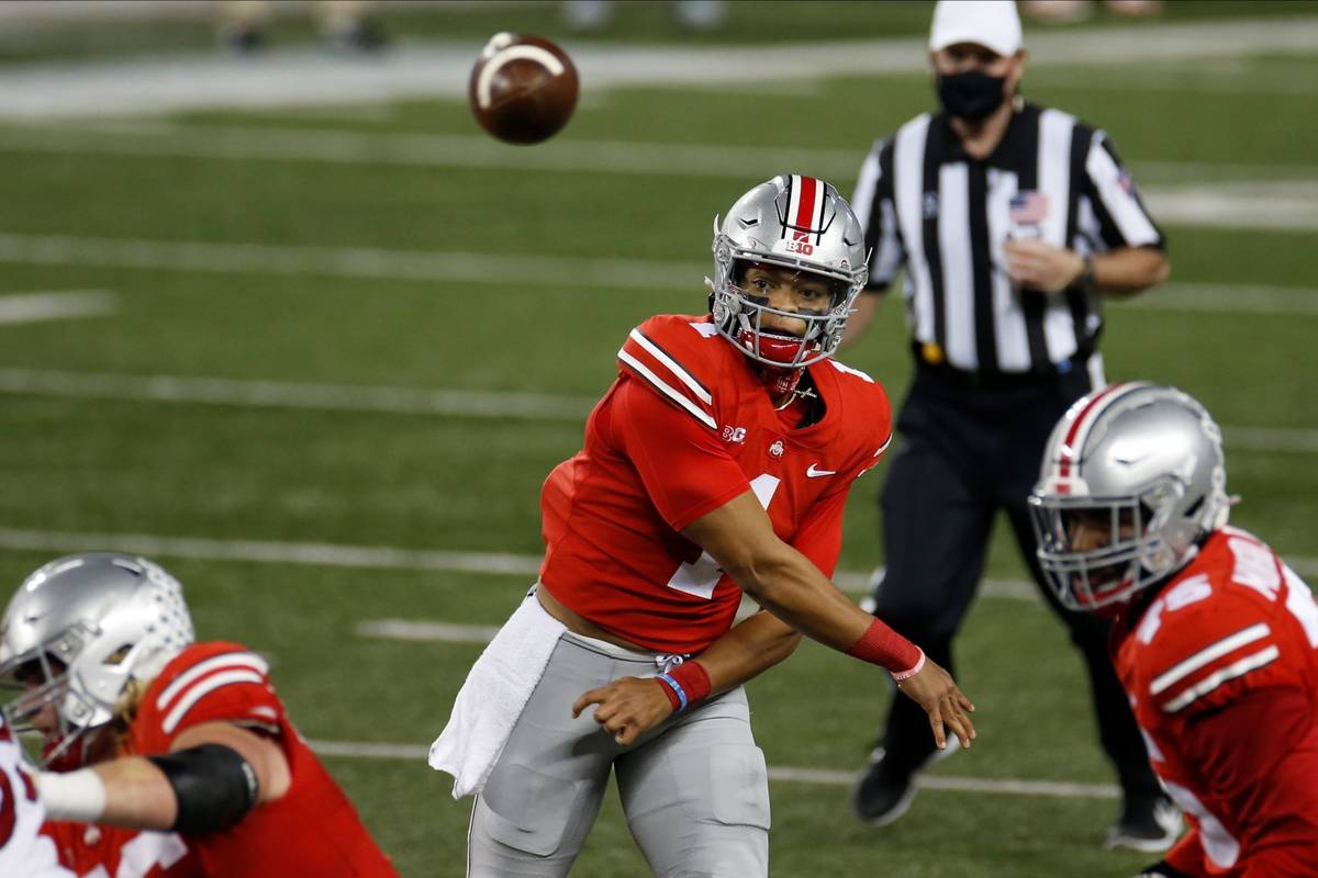 Ohio State quarterback Justin Fields throws a pass against Rutgers during the first half of an ...