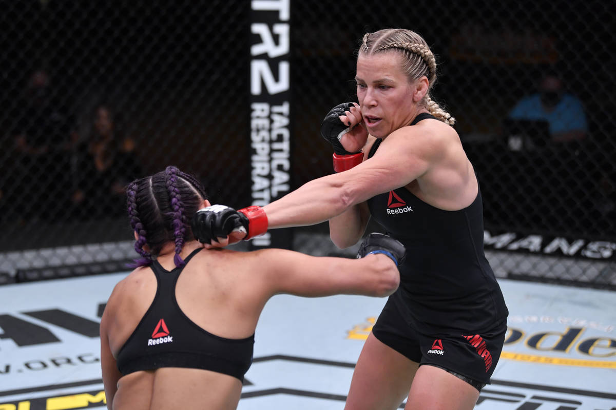 (R-L) Katlyn Chookagian punches Cynthia Calvillo in their women's flyweight bout during the UFC ...